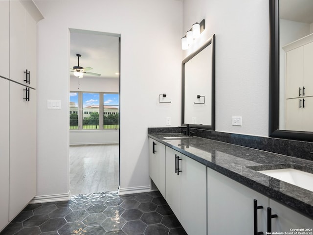 bathroom with tile patterned flooring, vanity, and ceiling fan