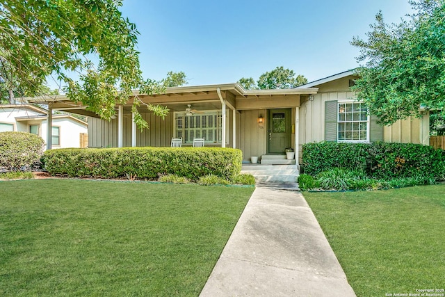 ranch-style house with a front yard and ceiling fan