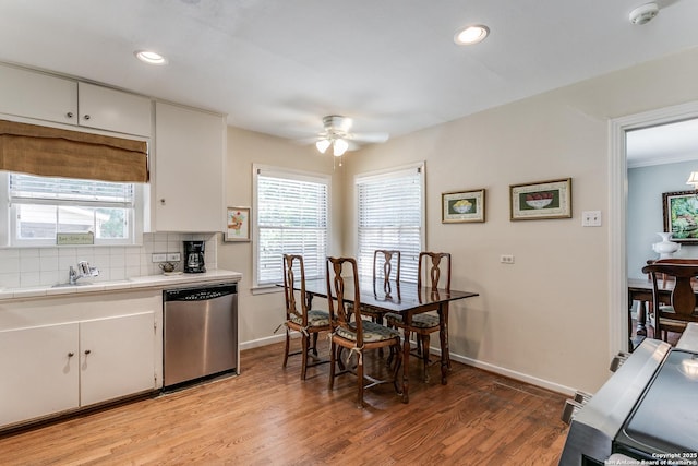 kitchen featuring white cabinetry, dishwasher, and tasteful backsplash