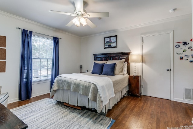 bedroom with crown molding, dark hardwood / wood-style floors, and ceiling fan