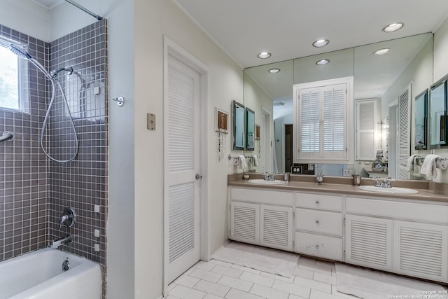 bathroom featuring tiled shower / bath combo, vanity, and tile patterned floors