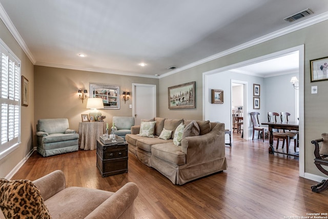 living room featuring wood-type flooring and crown molding