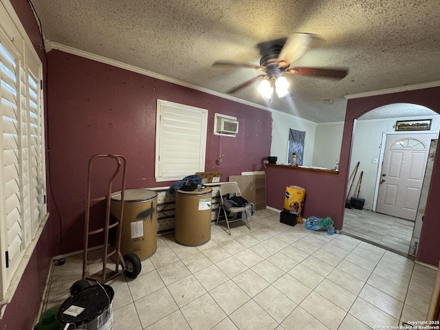 interior space featuring ceiling fan, ornamental molding, a wall mounted AC, and a textured ceiling