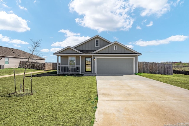 view of front facade featuring a garage, covered porch, and a front yard