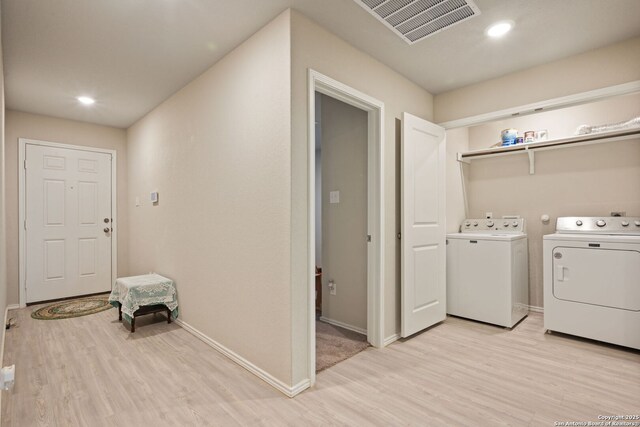 439 Agave Cir, Jourdanton, TX 78026 - washroom with independent washer and dryer and light hardwood / wood-style flooring