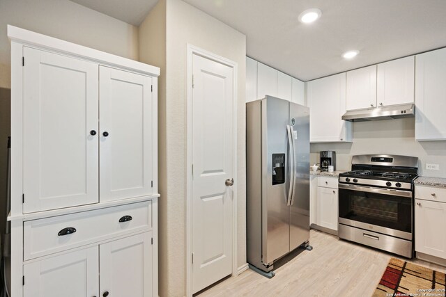 439 Agave Cir, Jourdanton, TX 78026 - kitchen featuring appliances with stainless steel finishes, light wood-type flooring, and white cabinets
