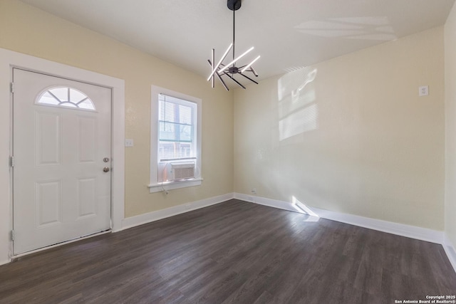 entrance foyer with dark hardwood / wood-style floors and a chandelier