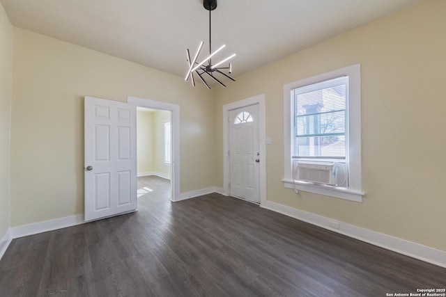 foyer entrance with cooling unit, a notable chandelier, and dark wood-type flooring