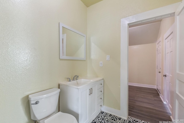 bathroom with vanity, hardwood / wood-style floors, and toilet