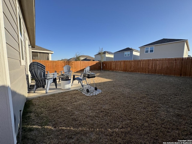 view of yard featuring an outdoor fire pit and a patio