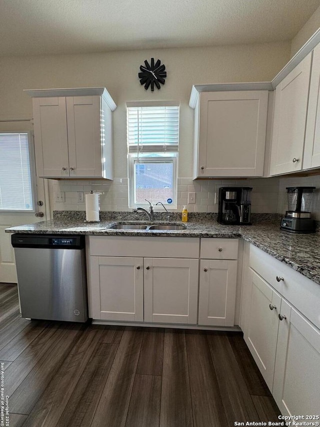 kitchen with white cabinetry, sink, dishwasher, and stone counters