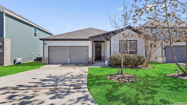 view of front of property featuring a garage, a front yard, and cooling unit