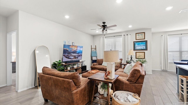 living room featuring ceiling fan and light wood-type flooring