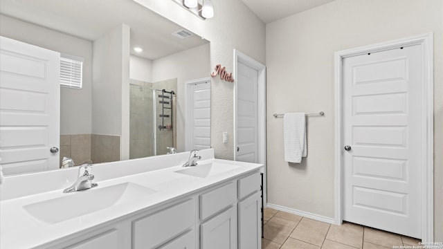 2437 Hiddenbrooke Trce, Seguin, TX 78155 - bathroom with vanity, tile patterned flooring, and a tile shower
