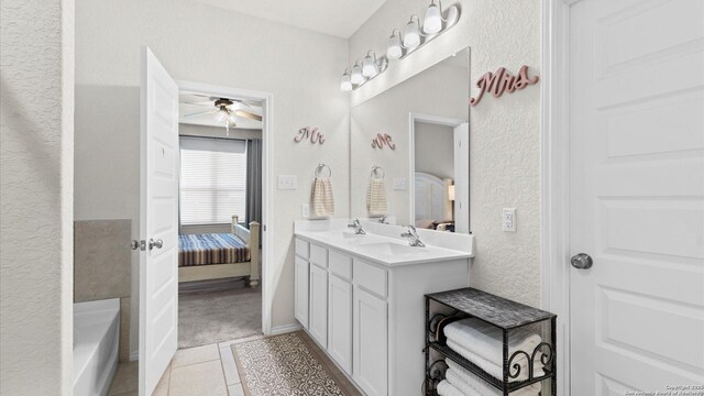 2437 Hiddenbrooke Trce, Seguin, TX 78155 - bathroom with tile patterned flooring, vanity, a bathtub, and ceiling fan