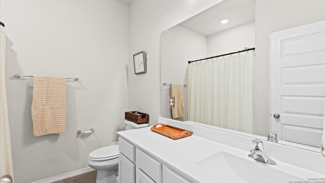 2437 Hiddenbrooke Trce, Seguin, TX 78155 - bathroom featuring a shower with curtain, vanity, and toilet