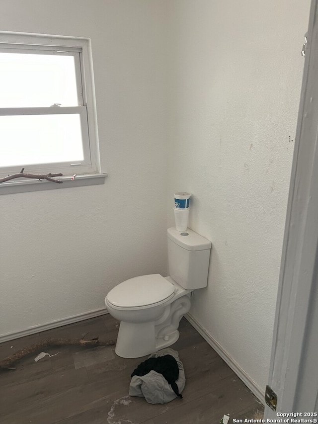 bathroom featuring hardwood / wood-style floors and toilet