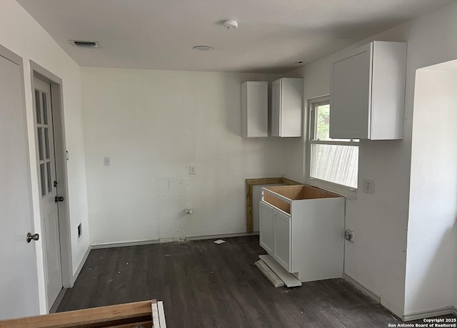 kitchen with white cabinetry and dark hardwood / wood-style floors