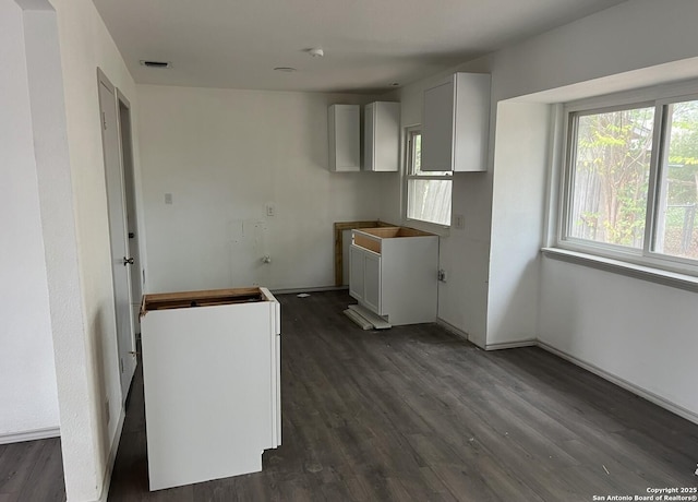 kitchen featuring white cabinetry and dark hardwood / wood-style flooring