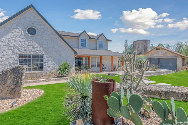 view of front of house featuring a garage and a front yard