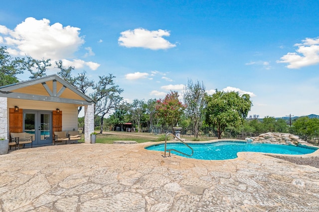 view of pool with a patio and french doors