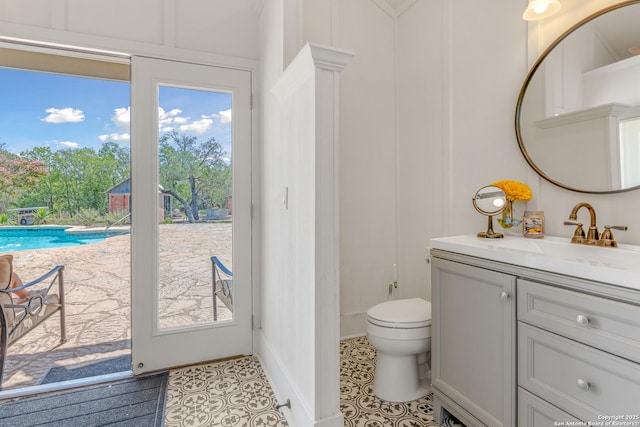 bathroom featuring tile patterned floors, vanity, toilet, and a wealth of natural light