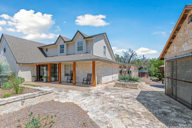 rear view of property featuring a patio area