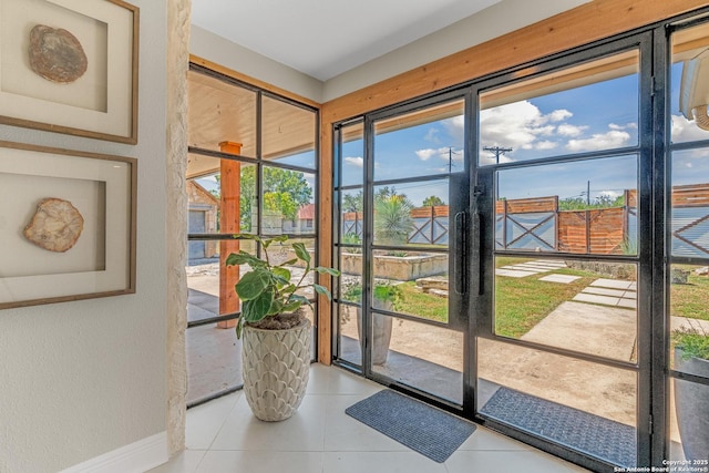 doorway to outside featuring light tile patterned floors