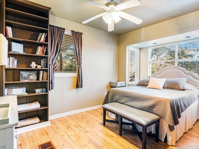 bedroom with ceiling fan and hardwood / wood-style floors