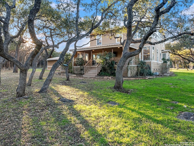 exterior space with a lawn and a porch