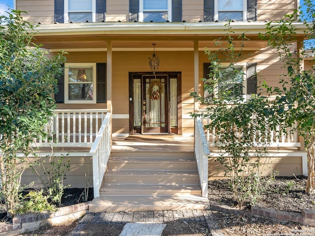 view of exterior entry featuring a porch