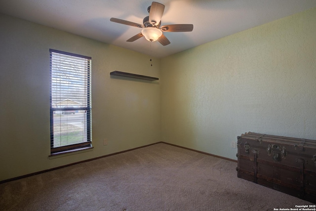 carpeted empty room featuring ceiling fan