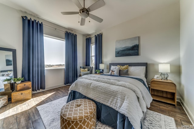 bedroom with hardwood / wood-style flooring, baseboards, and a ceiling fan