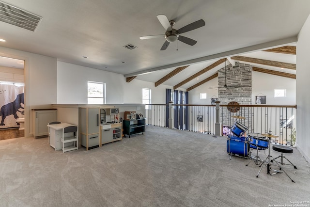 interior space featuring a ceiling fan, visible vents, beamed ceiling, and light carpet