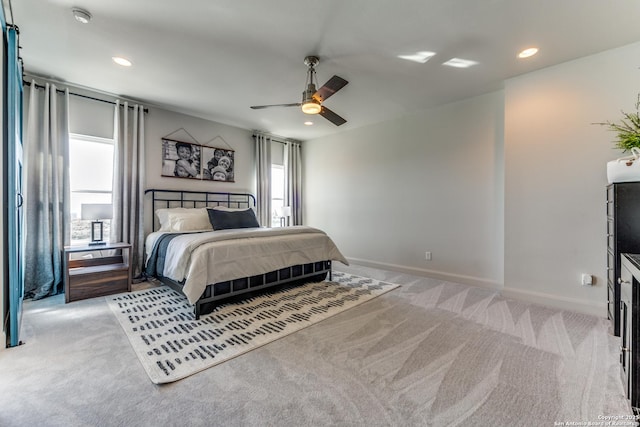 bedroom featuring light carpet, recessed lighting, a ceiling fan, and baseboards