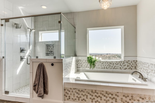 bathroom featuring a garden tub and a shower stall