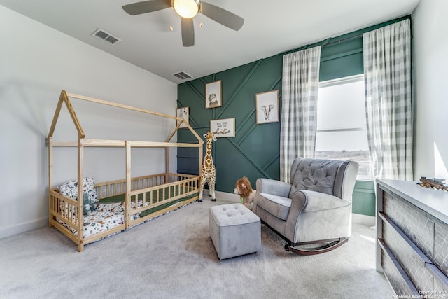 carpeted bedroom with ceiling fan, visible vents, and baseboards