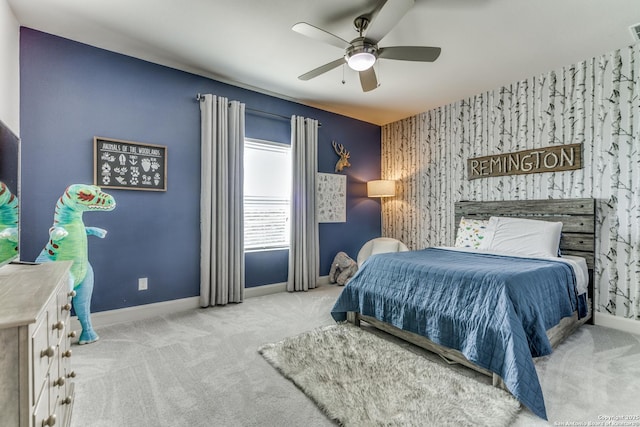 bedroom featuring carpet floors, an accent wall, and baseboards