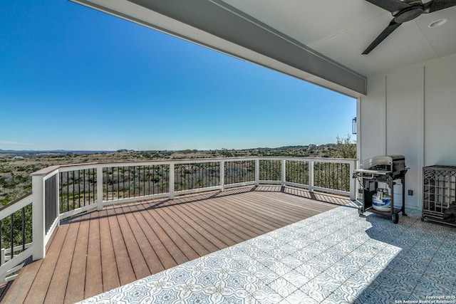 wooden terrace featuring ceiling fan and area for grilling