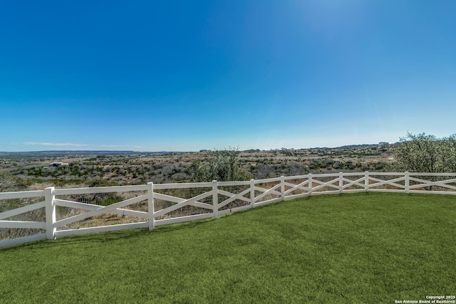 view of gate featuring a yard and fence