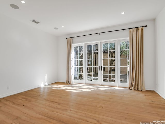 spare room with light hardwood / wood-style floors