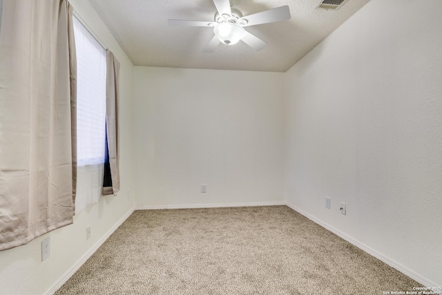 empty room featuring carpet flooring, a textured ceiling, and ceiling fan