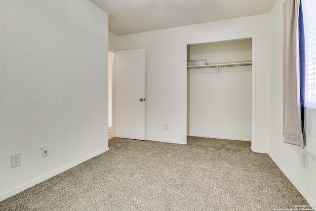 unfurnished bedroom with carpet floors and a closet