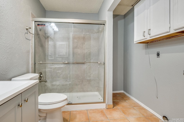 bathroom with tile patterned flooring, an enclosed shower, vanity, a textured ceiling, and toilet