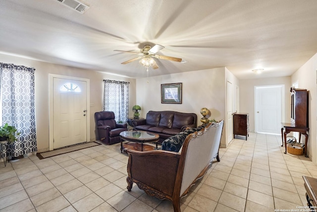 tiled living room with ceiling fan