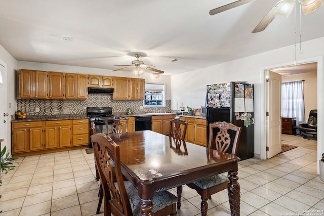 dining space featuring a healthy amount of sunlight, sink, and light tile patterned floors