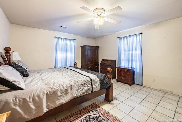 tiled bedroom with ceiling fan