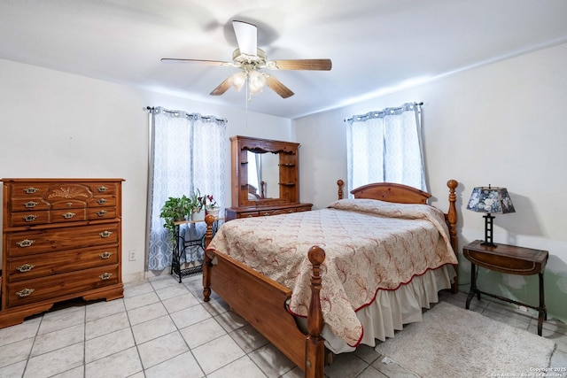 tiled bedroom featuring ceiling fan