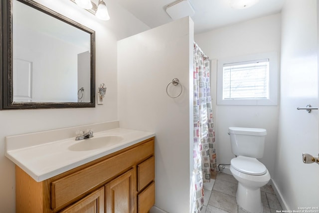 bathroom featuring vanity, tile patterned floors, and toilet