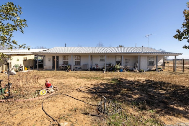 rear view of house featuring cooling unit